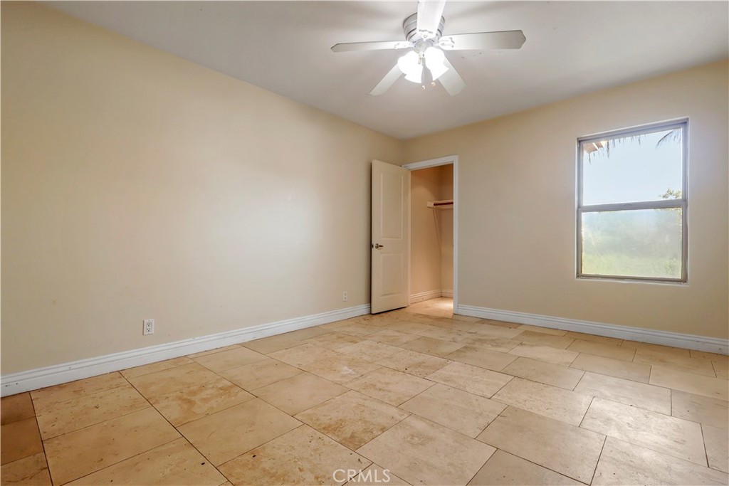 17100 Apple Street Bellflower, CA 90706 - Photo 24 of 38 an empty room with windows and fan