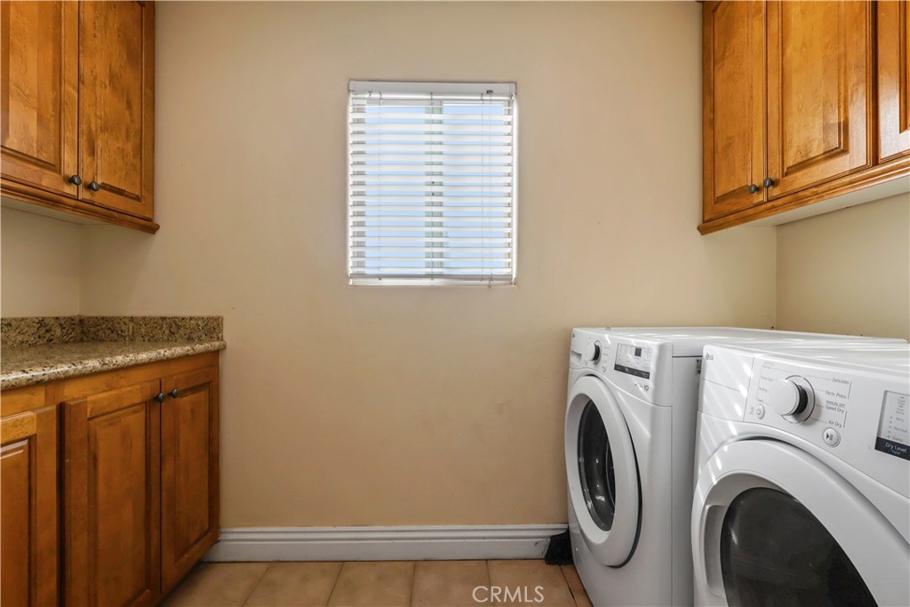 17100 Apple Street Bellflower, CA 90706 - Photo 26 of 38 a view of washer and dryer with kitchen in the background