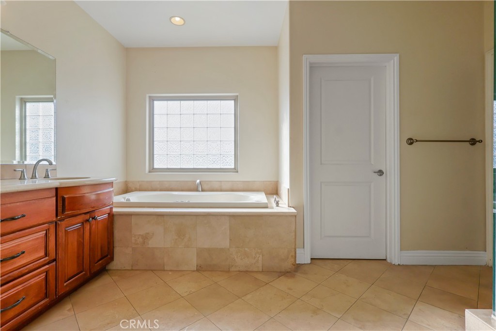 17100 Apple Street Bellflower, CA 90706 - Photo 31 of 38 a spacious bathroom with a tub sink and mirror