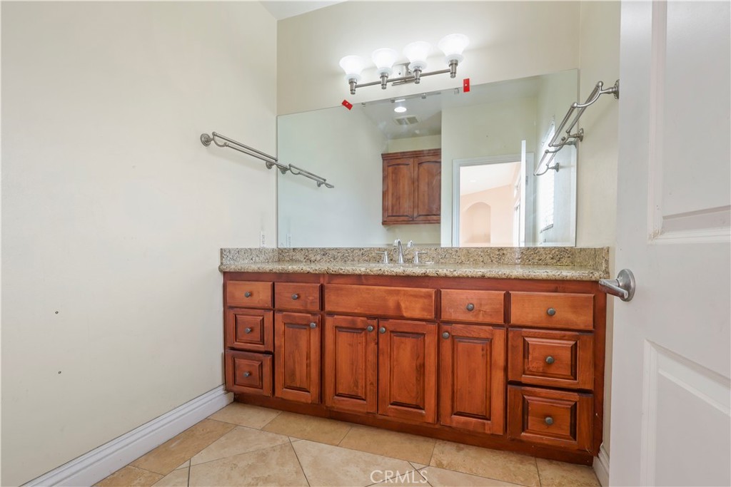 17100 Apple Street Bellflower, CA 90706 - Photo 35 of 38 a bathroom with a sink and a mirror