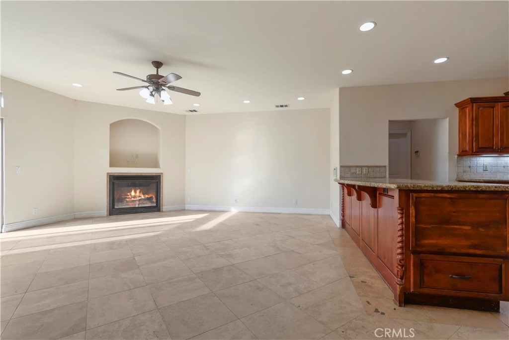 17100 Apple Street Bellflower, CA 90706 - Photo 8 of 38 a view of an empty room with a fireplace and a fan
