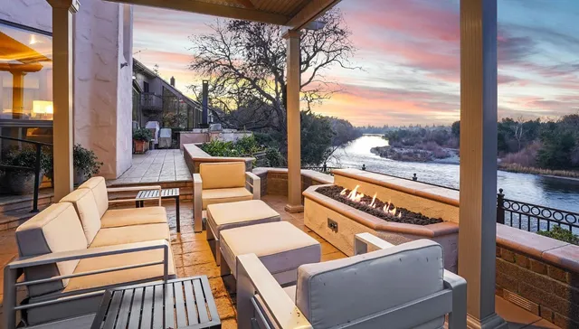 a view of a livingroom with furniture wooden floor a flat screen tv and a floor to ceiling window