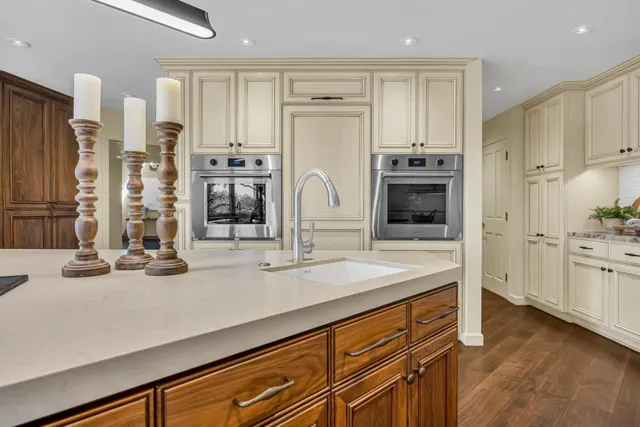 a front view of a house with a yard and a garden