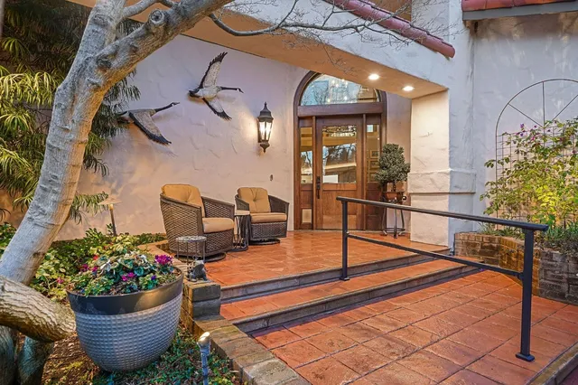 a living room with fireplace furniture and a kitchen area