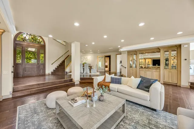 a view of a livingroom with furniture hardwood floor and a large window