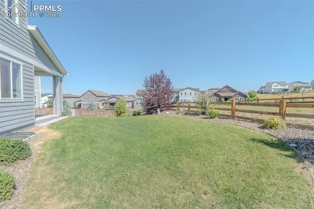 an aerial view of a house with a yard and a fountain