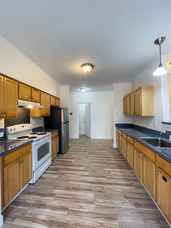 12 Humphreys Street, Unit 8 Boston, MA 02125 - Photo 6 of 7 a large kitchen with cabinets and wooden floor