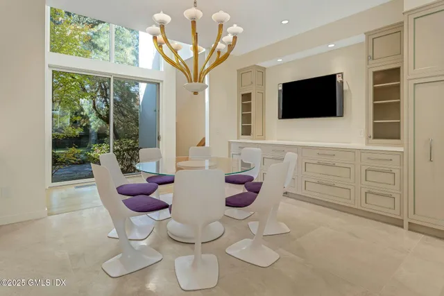 a kitchen with cabinets appliances and a large window