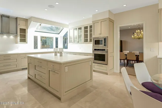 a view of a dining room with furniture a chandelier and wooden floor