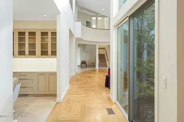 a view of an entryway with wooden floor