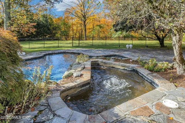 a view of backyard with wooden fence