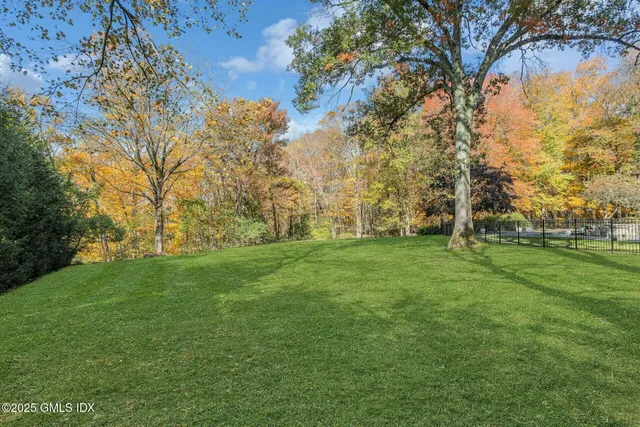 an aerial view of a house with a yard and lake view