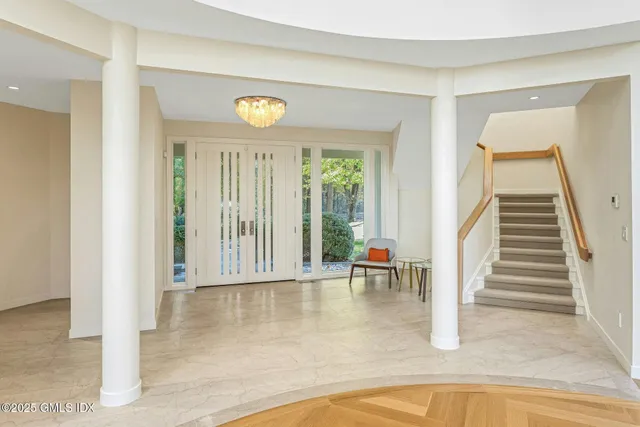 a living room with furniture and large windows