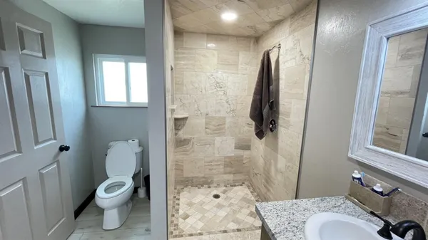 a backyard of a house with table and chairs