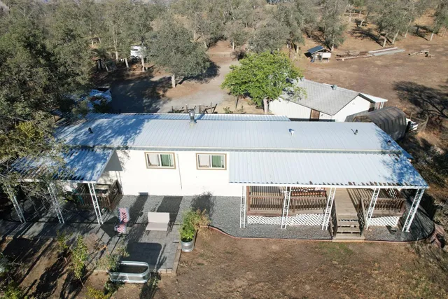 an aerial view of a house with outdoor space