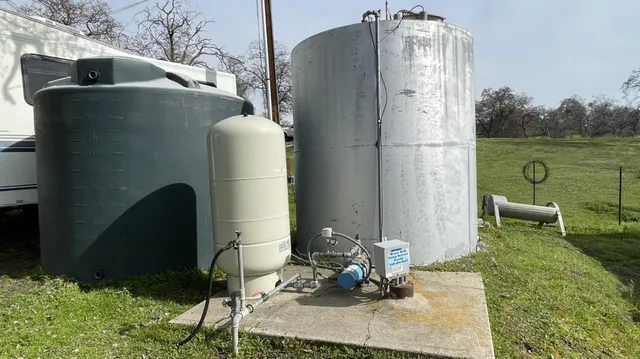 a aerial view of a house with a yard and lake view