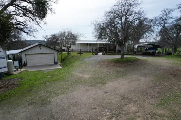 an aerial view of a house with a yard