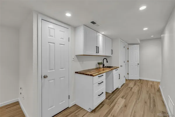 a kitchen with granite countertop a sink and wooden floor
