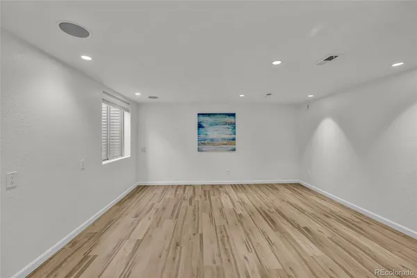 a view of room with window and wooden floor