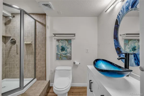 a bathroom with a toilet a sink and shower