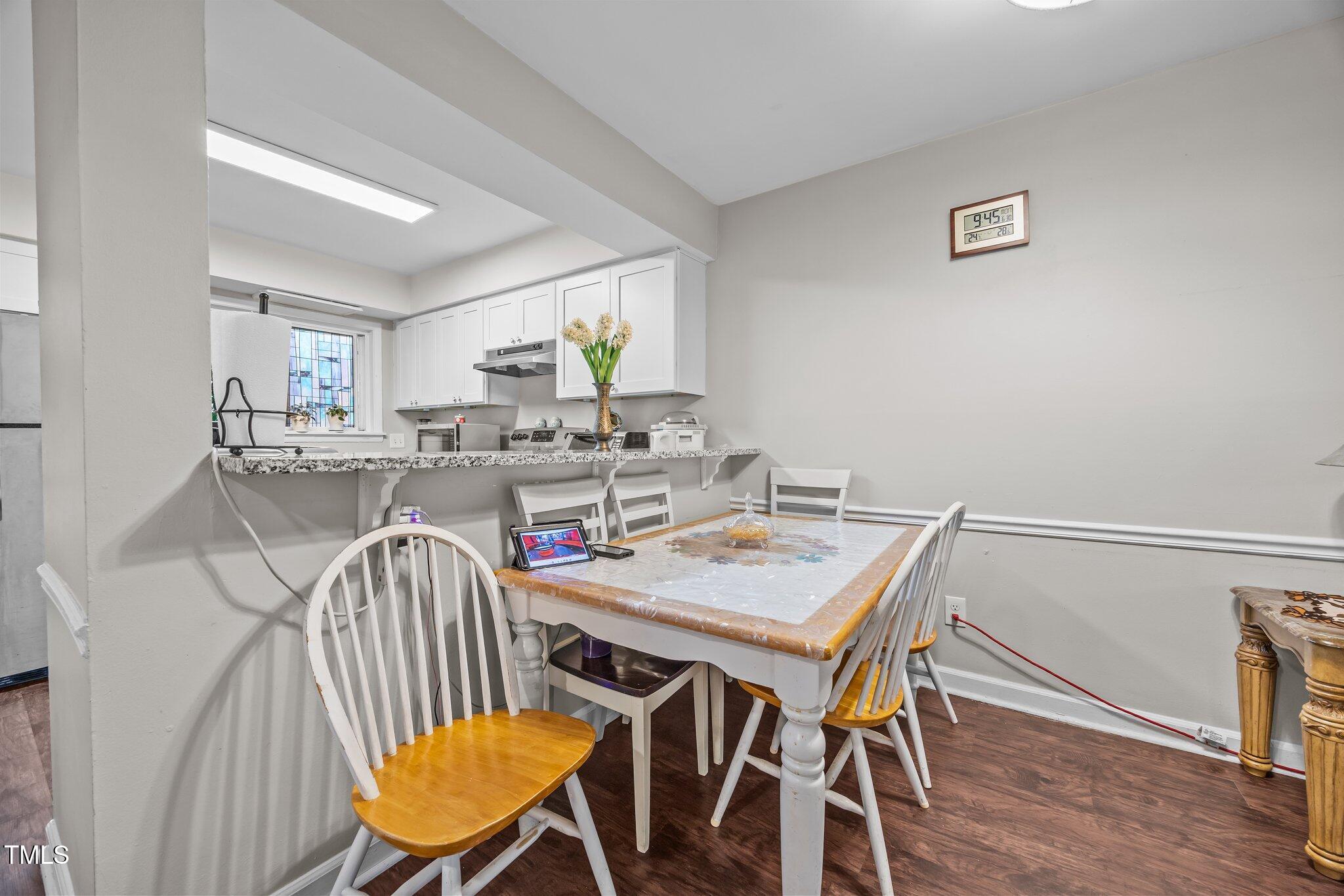 7020 Longstreet Drive, Unit A Raleigh, NC 27615 - Photo 11 of 27 a view of a dining room with furniture and wooden floor