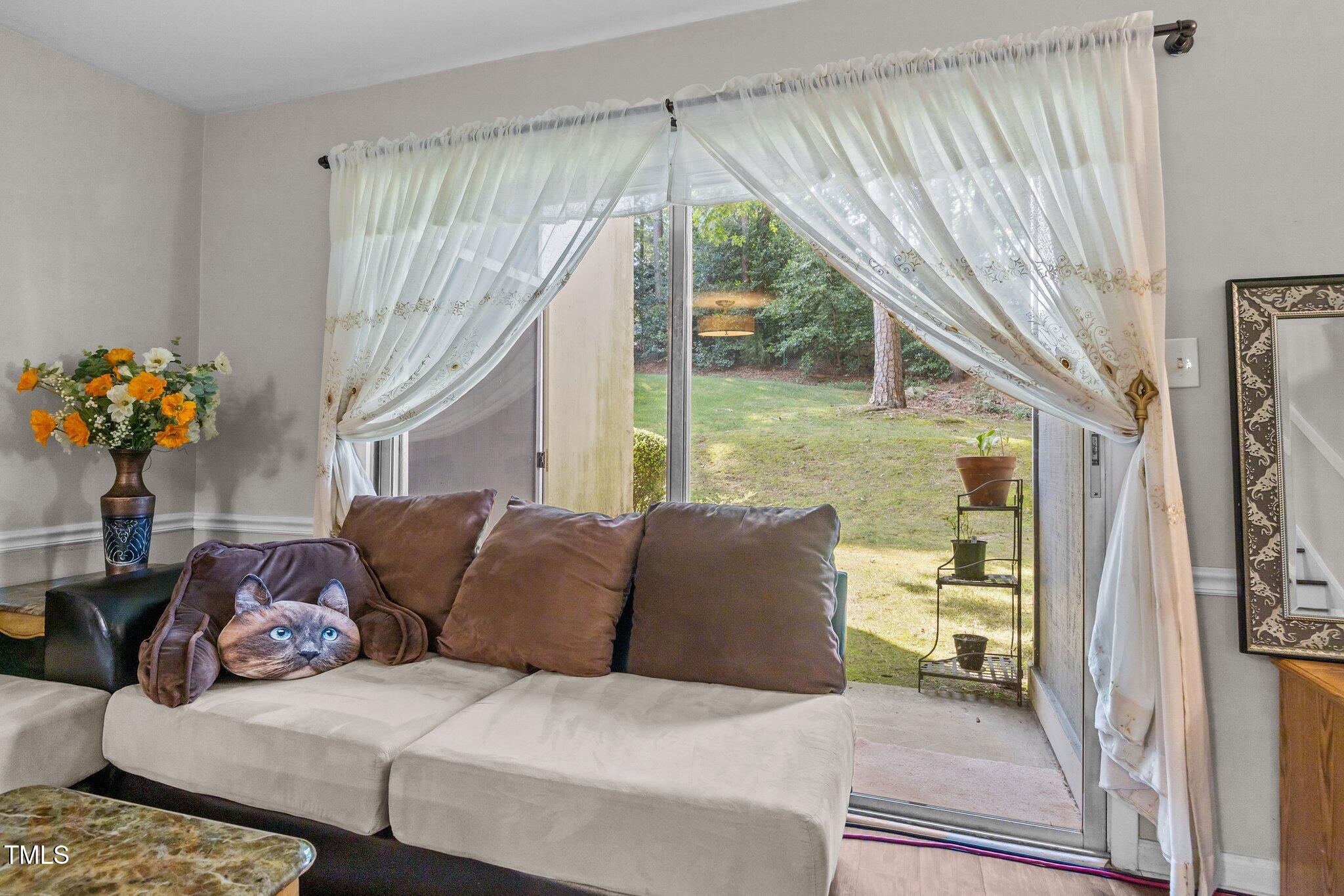 7020 Longstreet Drive, Unit A Raleigh, NC 27615 - Photo 17 of 27 a living room with furniture and a large window