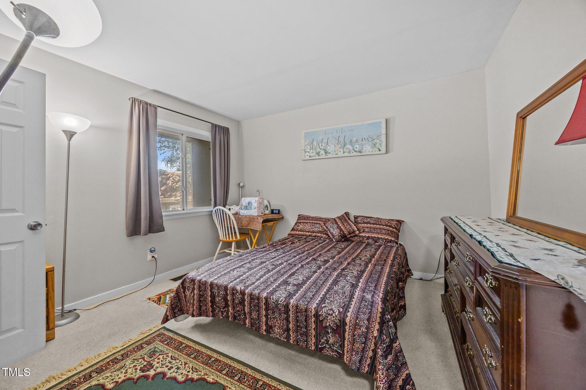 7020 Longstreet Drive, Unit A Raleigh, NC 27615 - Photo 21 of 27 a bedroom with a bed and a window