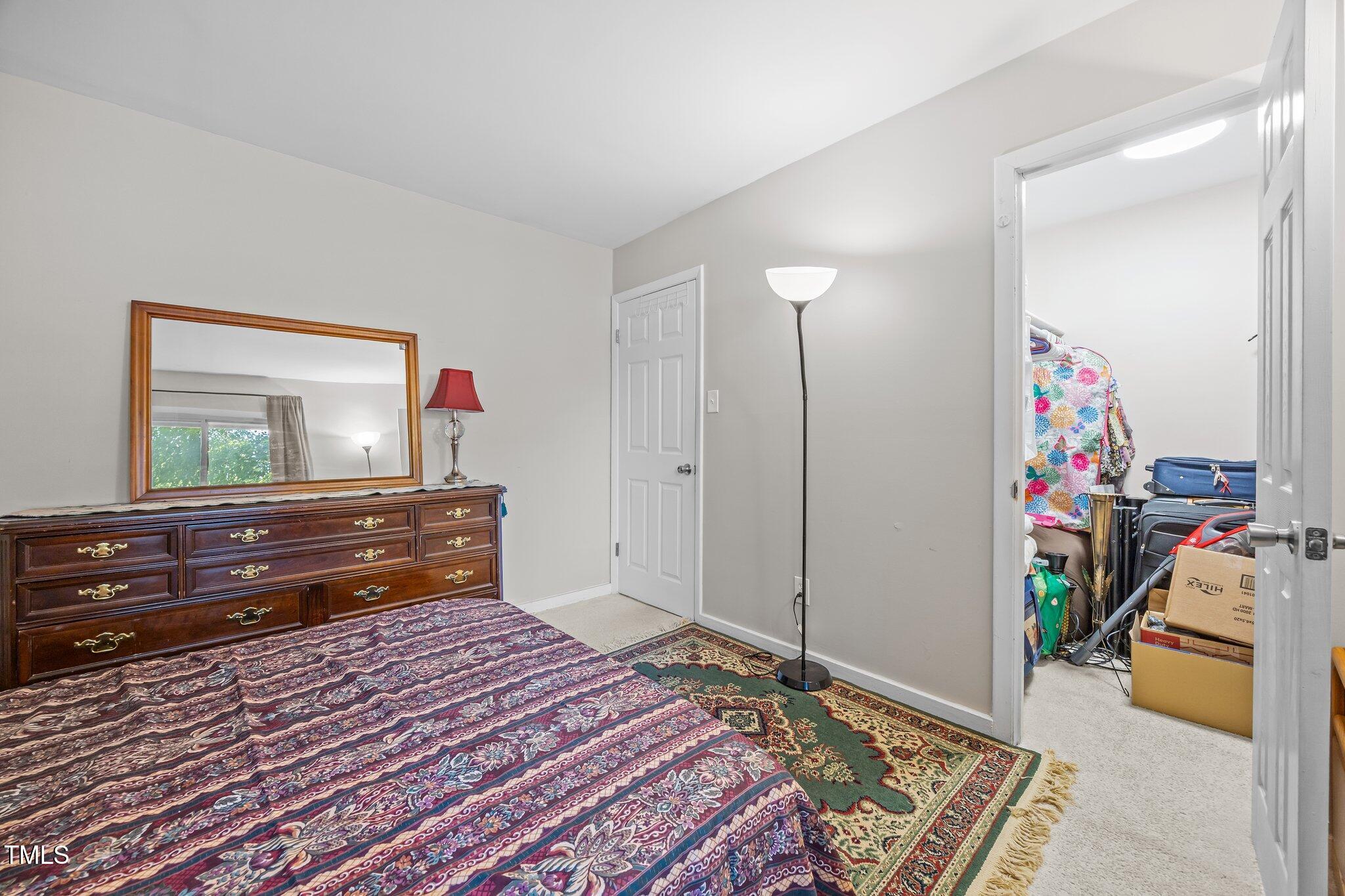 7020 Longstreet Drive, Unit A Raleigh, NC 27615 - Photo 22 of 27 a bedroom with a bed and a dresser in it