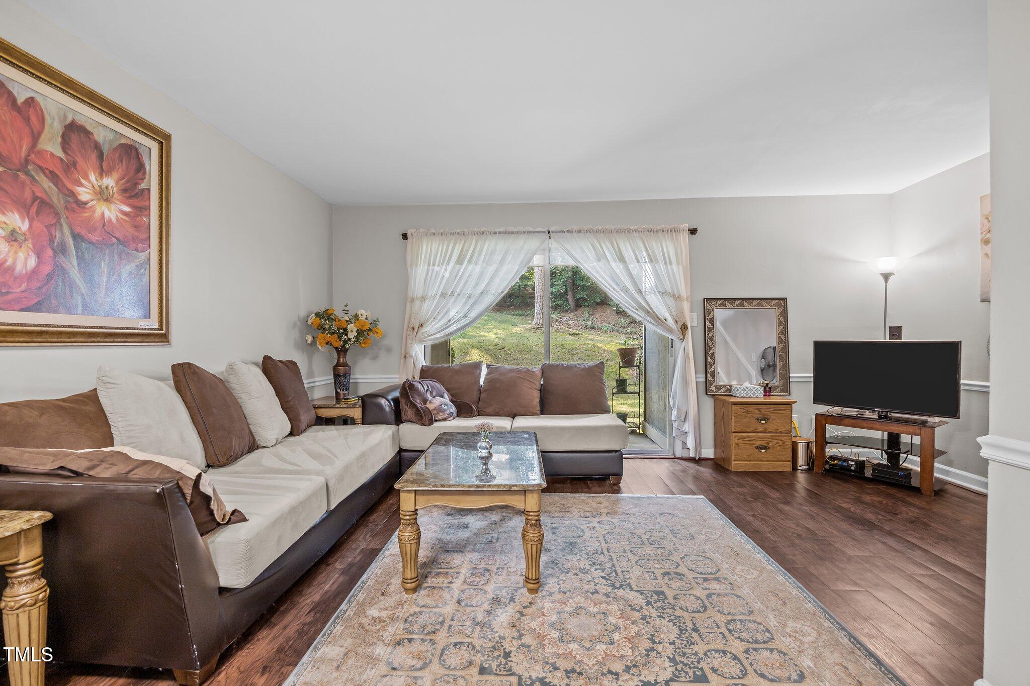 7020 Longstreet Drive, Unit A Raleigh, NC 27615 - Photo 10 of 27 a living room with furniture and a flat screen tv