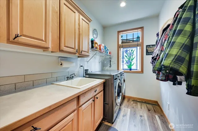 a view of a kitchen with furniture and wooden floor