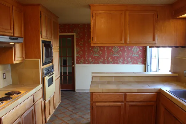 a kitchen with a stove and a refrigerator