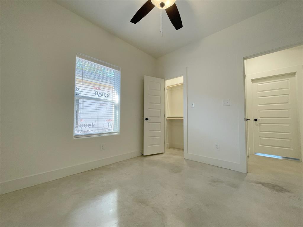 607 West Baker Street Denison, TX 75020 - Photo 13 of 19 Unfurnished bedroom with a walk in closet, ceiling fan, and a closet