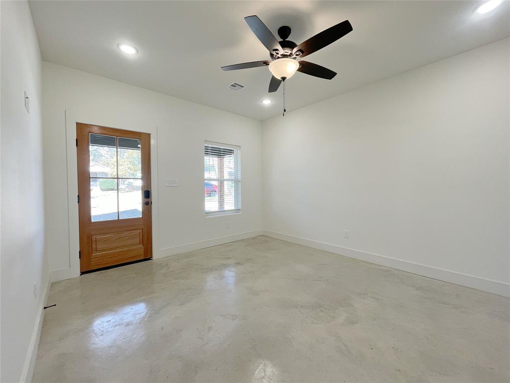 607 West Baker Street Denison, TX 75020 - Photo 3 of 19 Empty room featuring ceiling fan