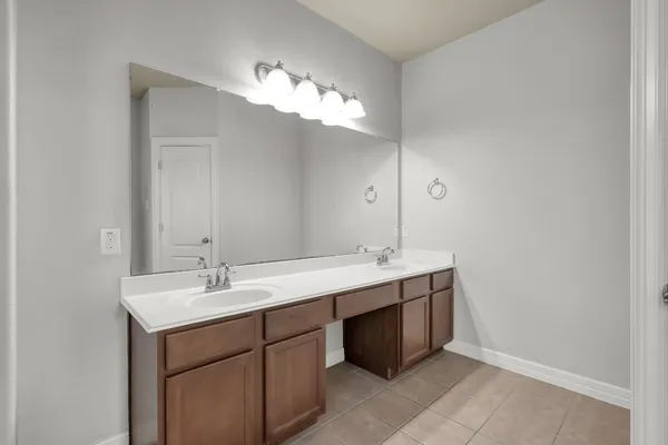 a bathroom with a tub sink and mirror