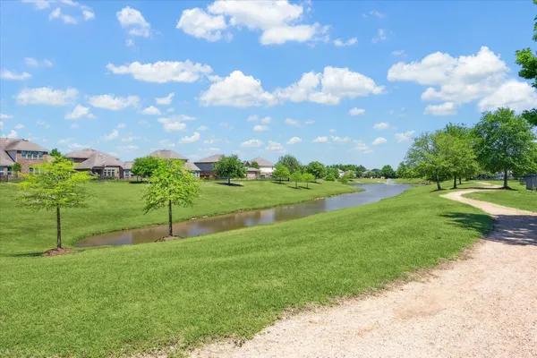 a view of a lake with a house in the background