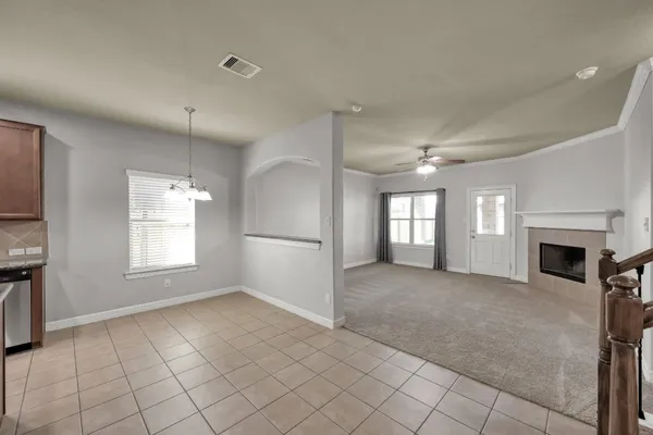a large kitchen with granite countertop a stove a sink dishwasher and a refrigerator