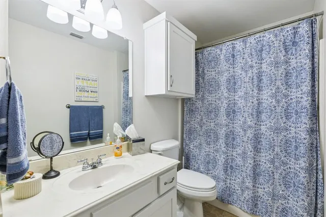 a view of a hallway with wooden floor and closet