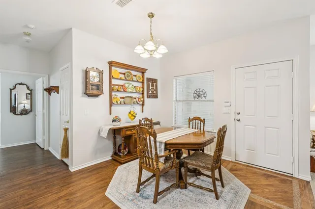 a view of a dining room with furniture and chandelier