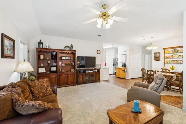 a kitchen with stainless steel appliances granite countertop a refrigerator sink and stove