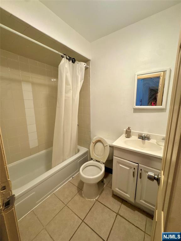 210 Main Street, Unit 2 Ridgefield Park, NJ 07660 - Photo 4 of 4 a bathroom with a granite countertop sink toilet and shower