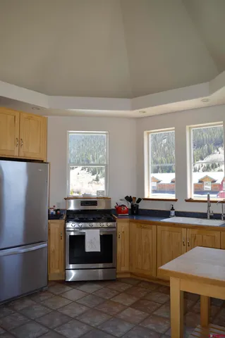 a kitchen with stainless steel appliances a stove sink and refrigerator
