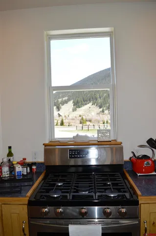 a stove top oven sitting inside of a kitchen
