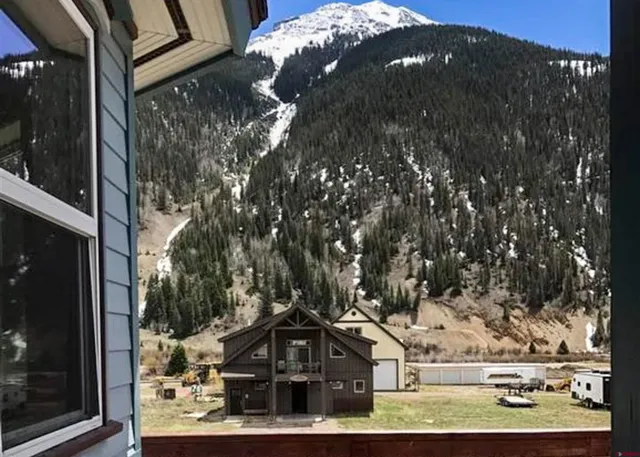 a view of staircase with railing and a floor to ceiling window
