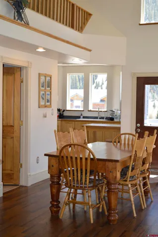 a view of a a dining room with furniture window and wooden floor
