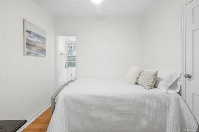 a bedroom with a bed and painting on the wall