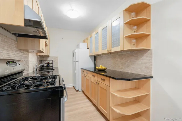 a kitchen with stainless steel appliances granite countertop a stove and a sink