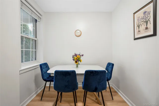 a view of a dining room with furniture and a window