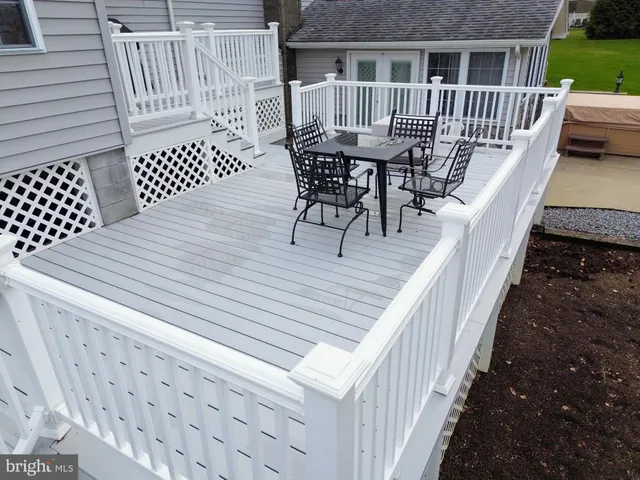 a view of a dining room with furniture a chandelier and wooden floor