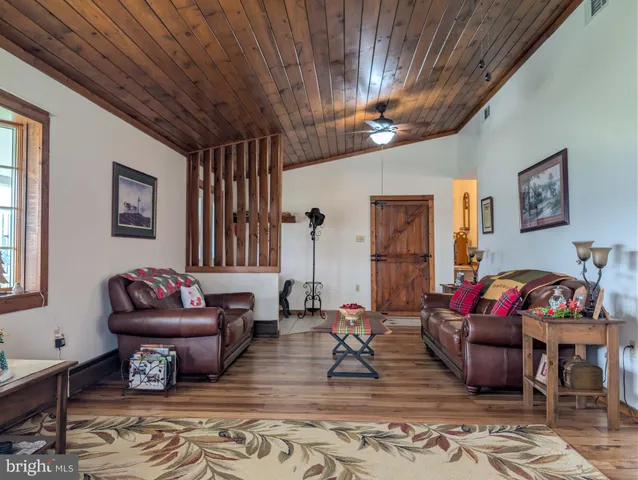 a living room with furniture and paintings on the wall