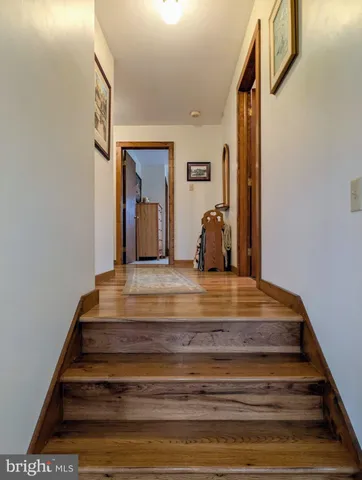 a front view of a house with a garden and trees